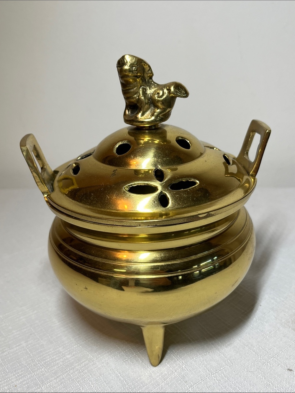 Antique Chinese brass incense burner
foo dog finial on the lid
three tripod feet